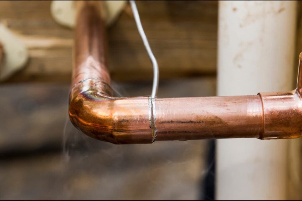 This is a photo of a copper pipe to BS864 with an end feed elbow, and lead free solder being installed maybe in Sunderland